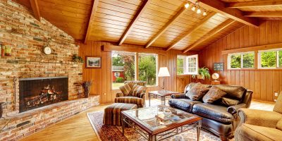 Luxury log cabin house interior. Living room with fireplace and
